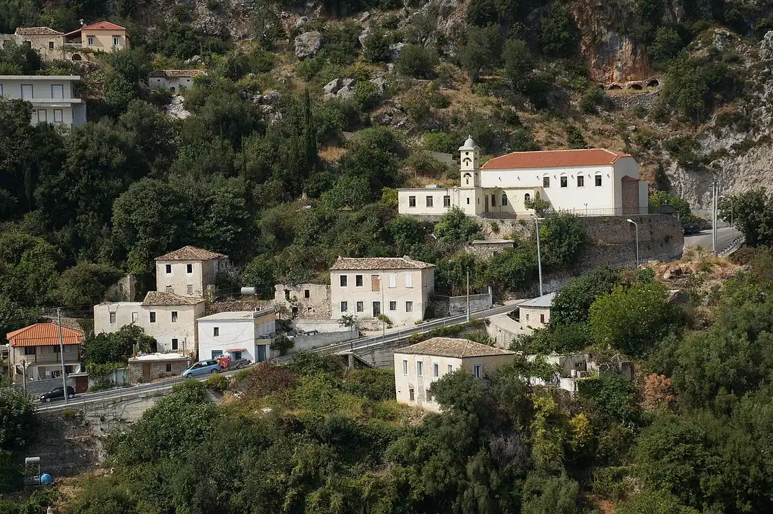 A small stone Orthodox church with a tiled roof in the village of Dhermi