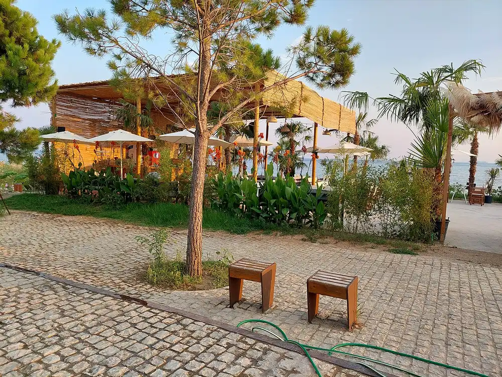 Busy pedestrian street of bars and restaurants behind the beach at Dhermi in August
