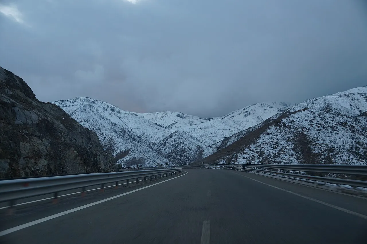 The A1 Nation's Highway near Kalimash under snow in winter, with mountains behind