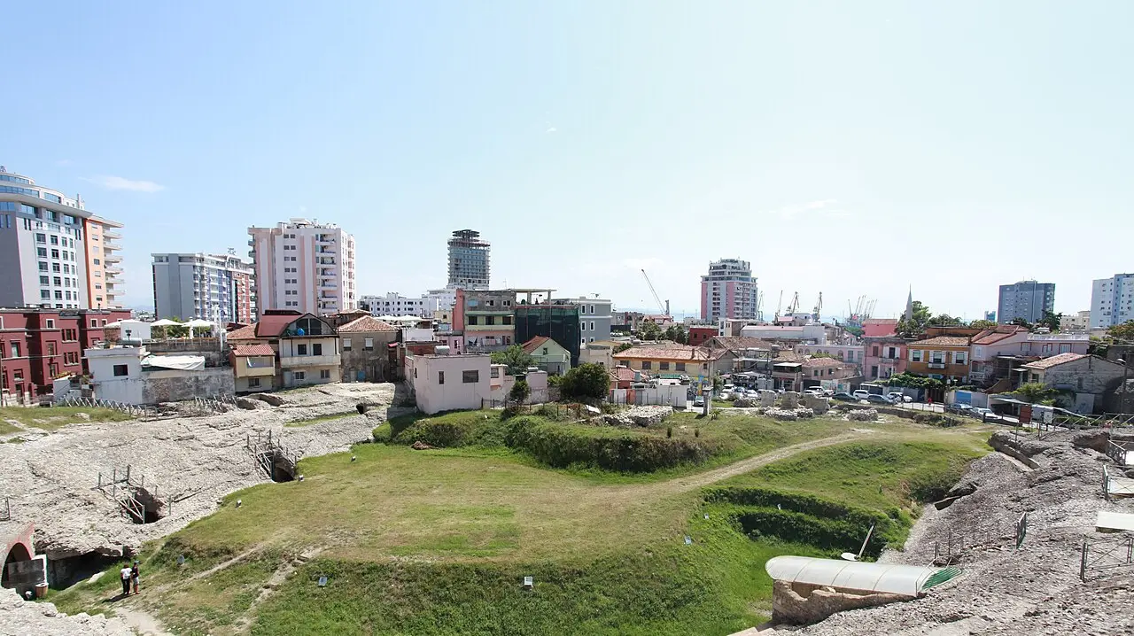 The stone tiers of the Roman amphitheatre of Durrës set among the modern town