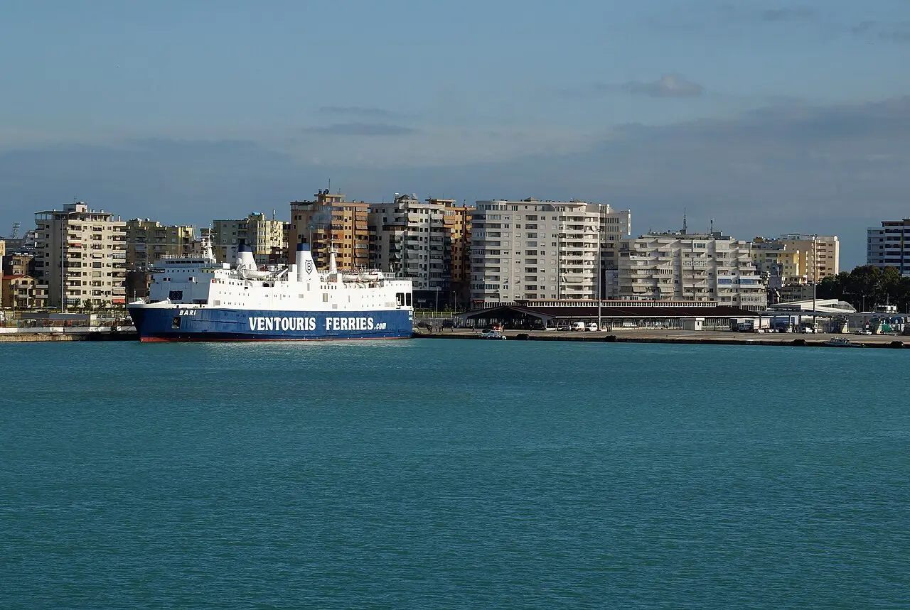 A large car ferry docked at the passenger terminal of the Port of Durrës