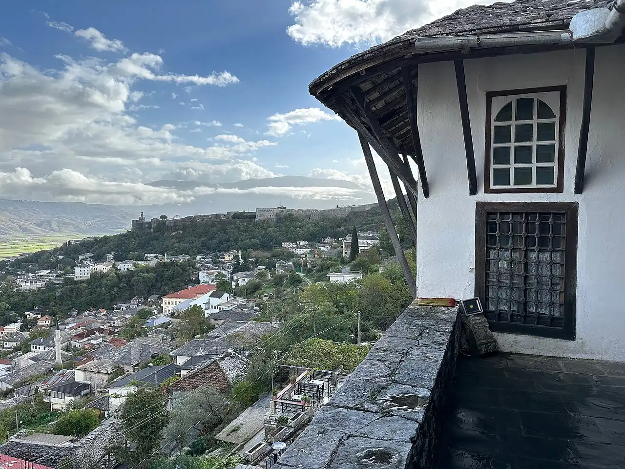 The view over Gjirokastër and the castle from the stone balcony of a tower-house