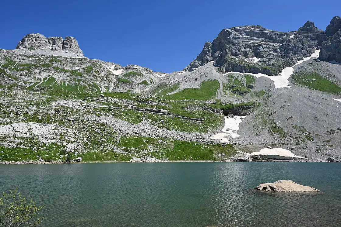 The high glacial cirque of Buni i Jezercës with snow patches and bare peaks