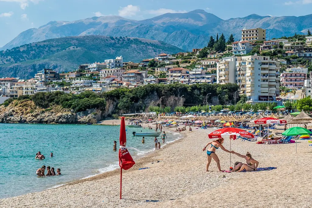 Potami beach at Himara with clear water and the mountains rising behind the sand