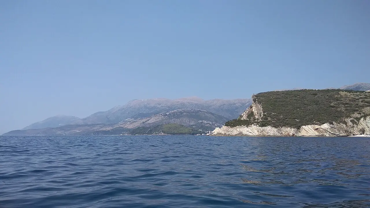 The Ceraunian coastline and a white cliff headland near Himara seen from a boat on the water