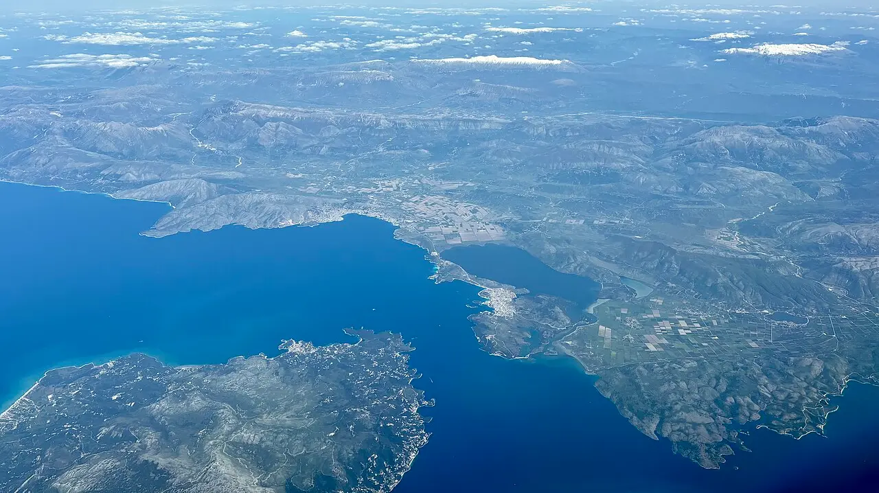 Aerial view of southern Albania where the deep blue Ionian meets a coast backed by mountains