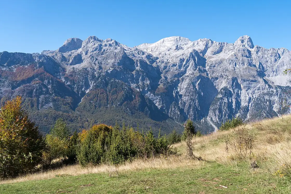 Wooded slopes and limestone peaks inside Theth National Park