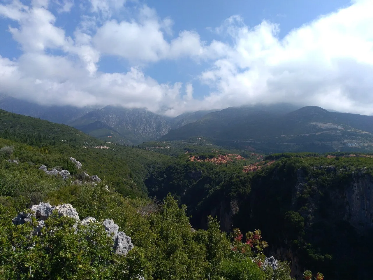 The Llogara pass road winding down toward the Ionian coast with the sea far below