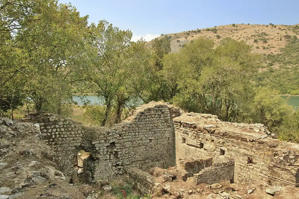Ancient stone ruins among trees at Butrint archaeological park near Saranda