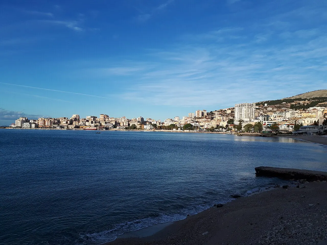Dense apartment buildings of Saranda climbing the hillside above the waterfront