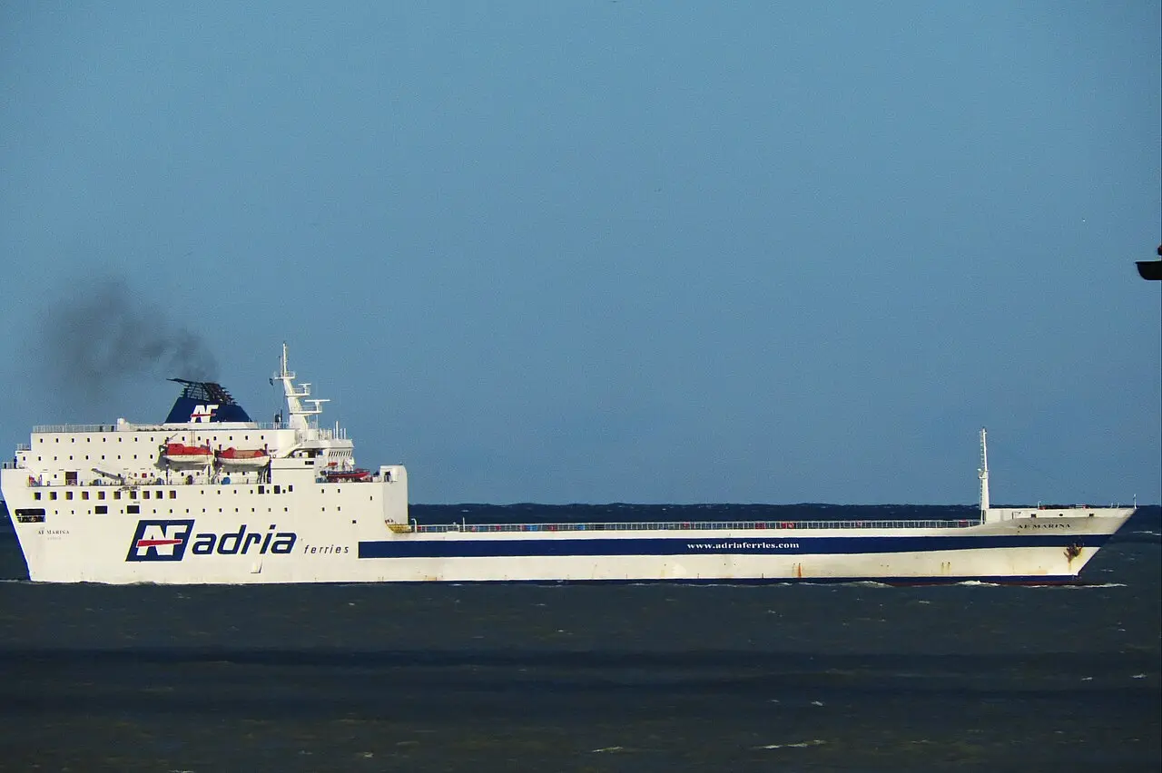 An Adria Ferries vessel underway on the Adriatic Sea off Ancona, Italy, under a blue sky