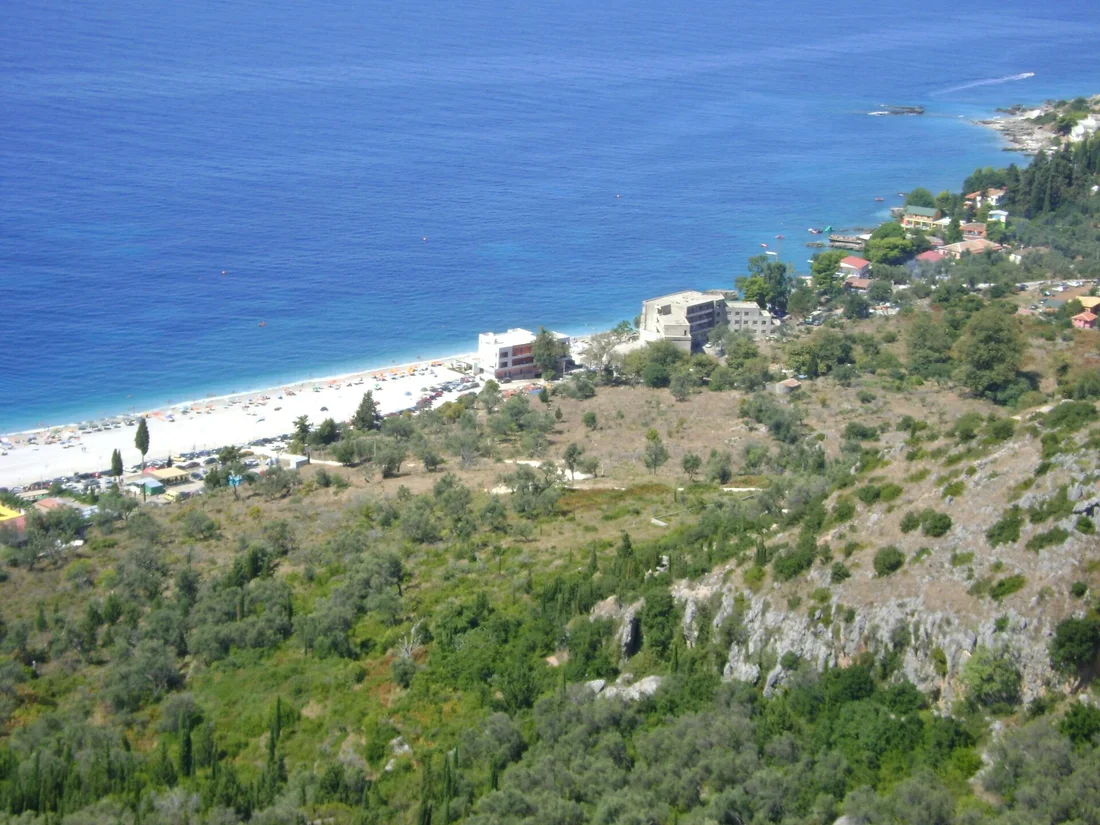 A small tent pitched on the pebbly shore at Dhërmi beach