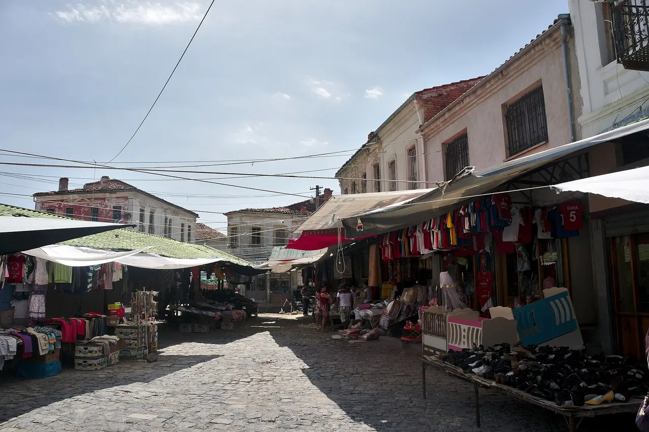 Open-air cafe tables in the Old Bazaar square of Korça