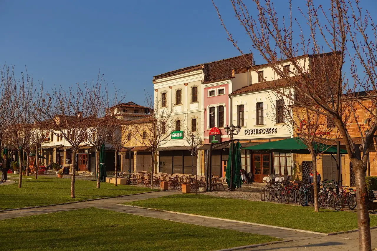 Restored stone arcades and shops of Korça's Old Bazaar in spring