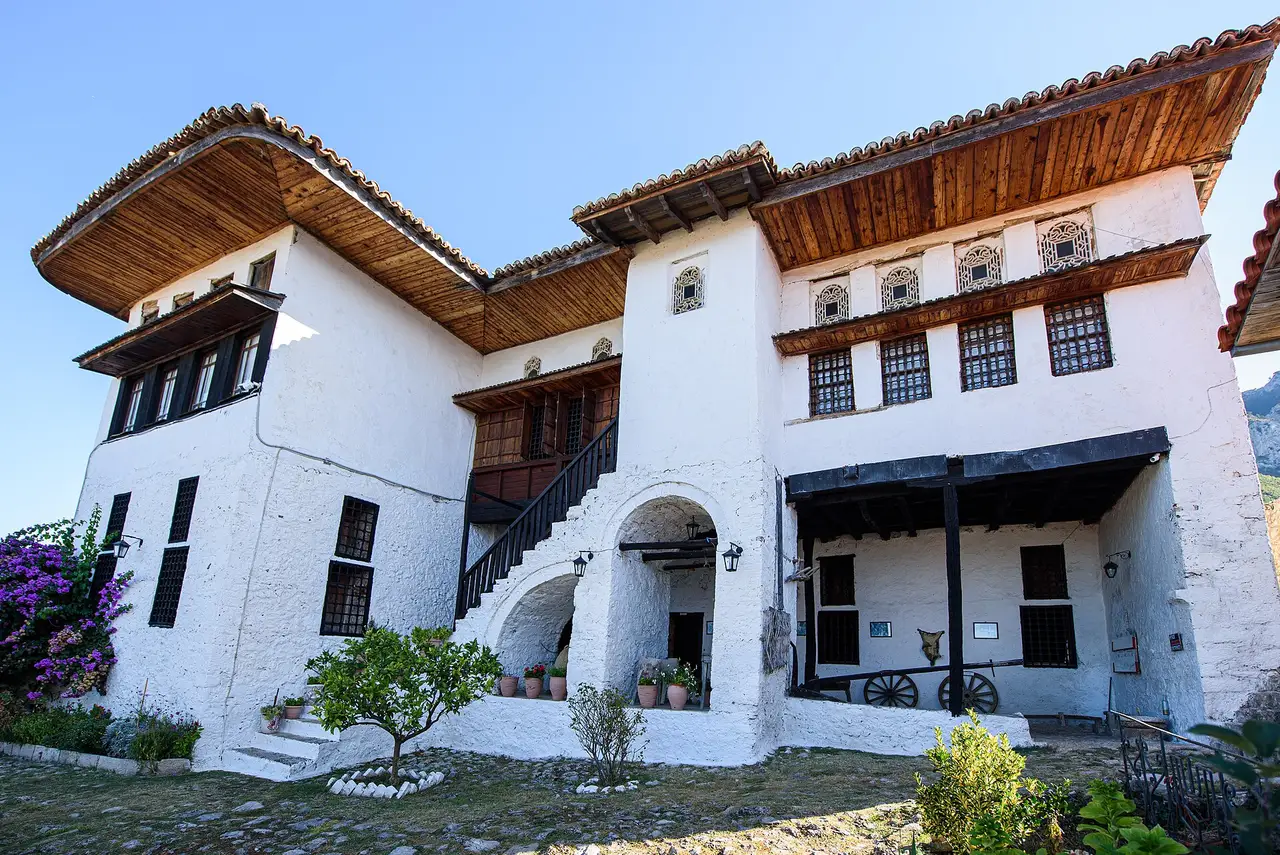 The white two-storey Ottoman house of the Kruja Ethnographic Museum, with wide overhanging wooden eaves, latticed upper windows and an external stone staircase