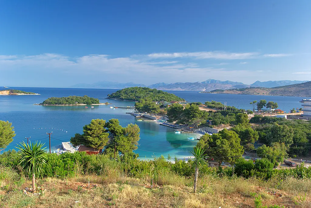 The small offshore islets of Ksamil rising from turquoise water under a clear sky