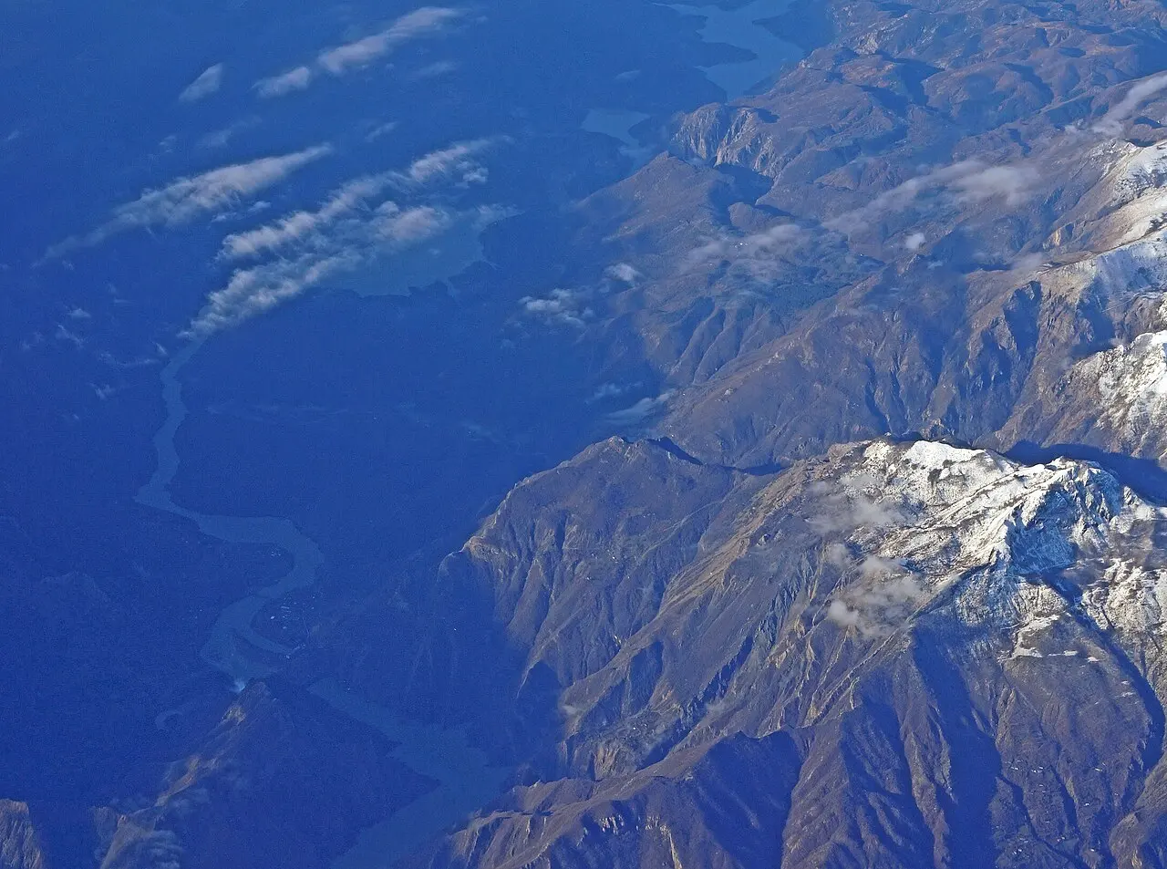 Aerial view of the Koman dam and the head of the reservoir where the ferry departs, ringed by mountains
