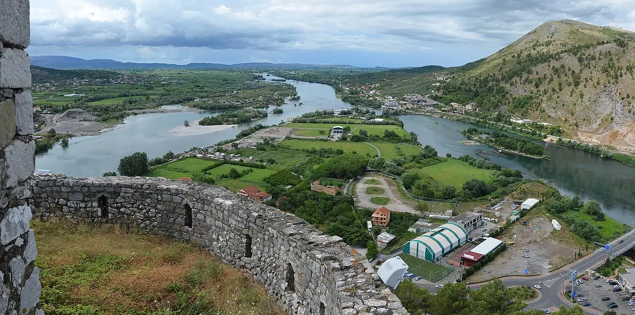 The walls of Rozafa Castle above Shkodra with the Buna river braiding across the green plain
