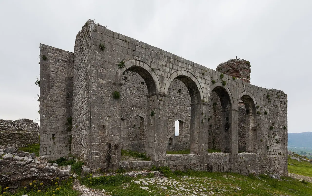 The roofless arches of St Stephen's church inside Rozafa Castle, later converted into a mosque, with the minaret base to the right
