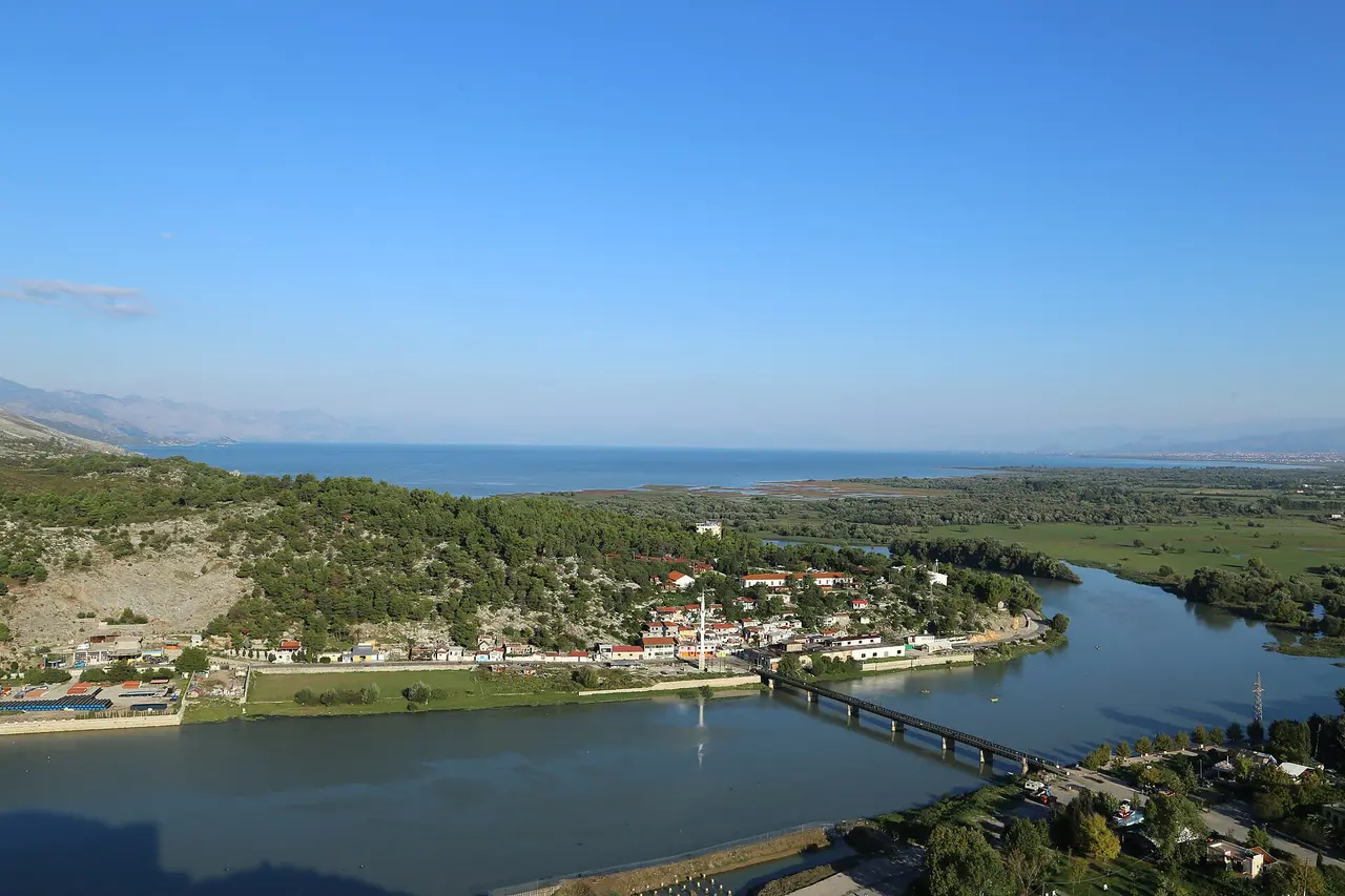 The Buna river, a small mosque minaret and the flat sheet of Lake Shkodra seen from the walls of Rozafa Castle