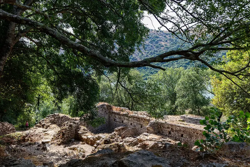Ancient stone ruins among trees at the Butrint archaeological park