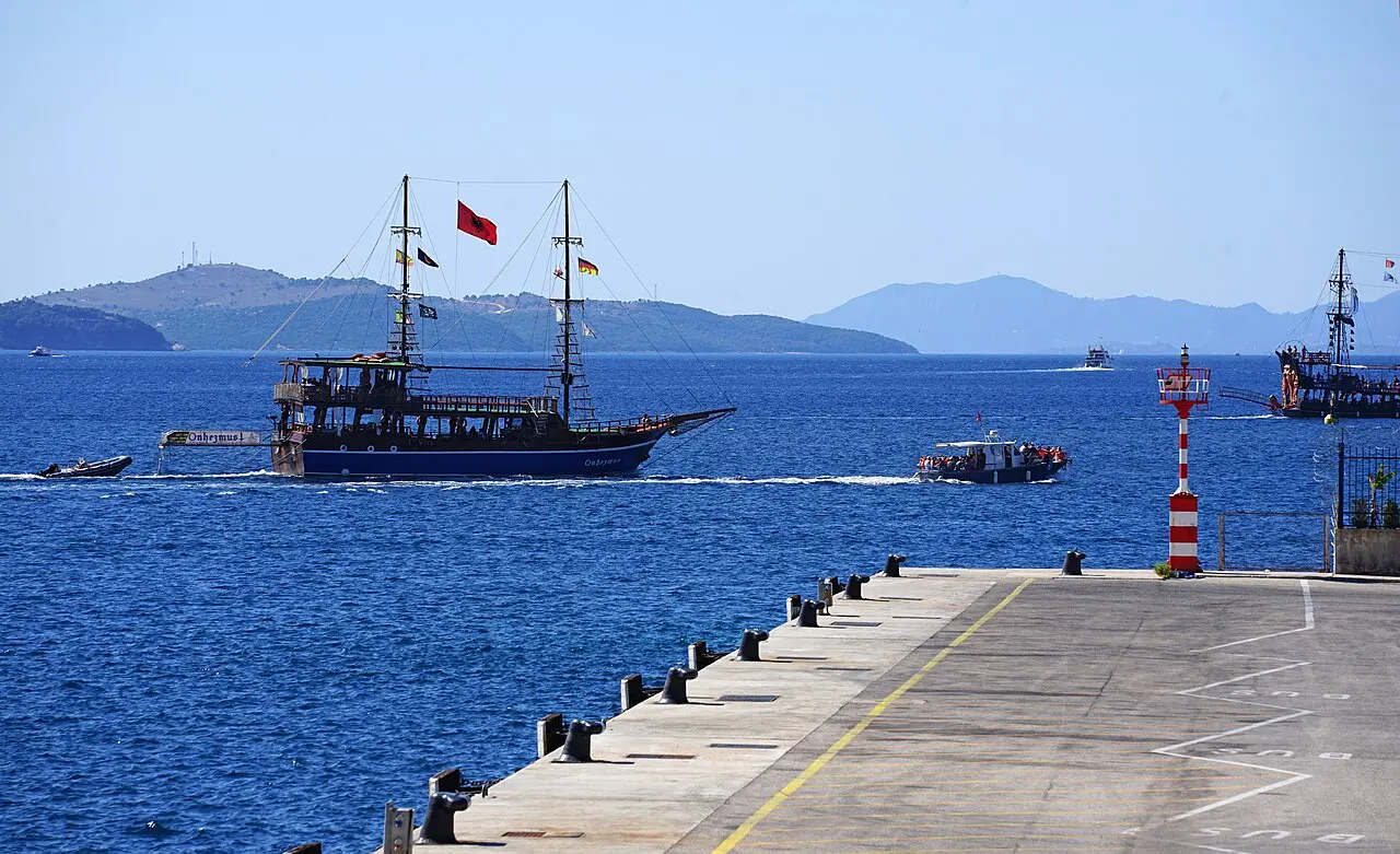 An excursion boat flying the Albanian flag leaving Saranda harbour