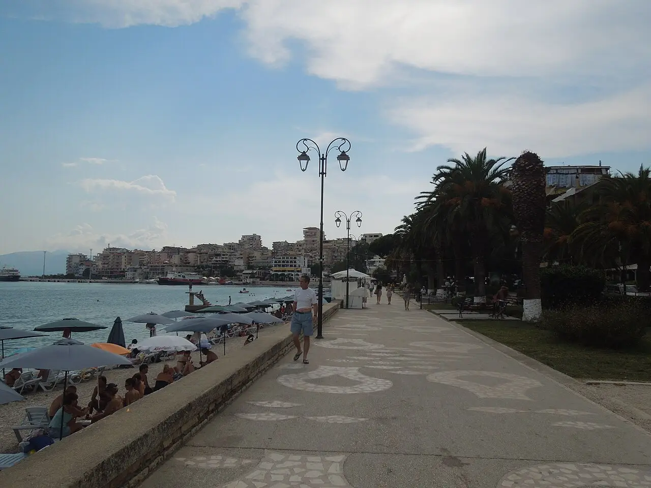 The palm-lined seafront promenade in Saranda with the town beach and bay