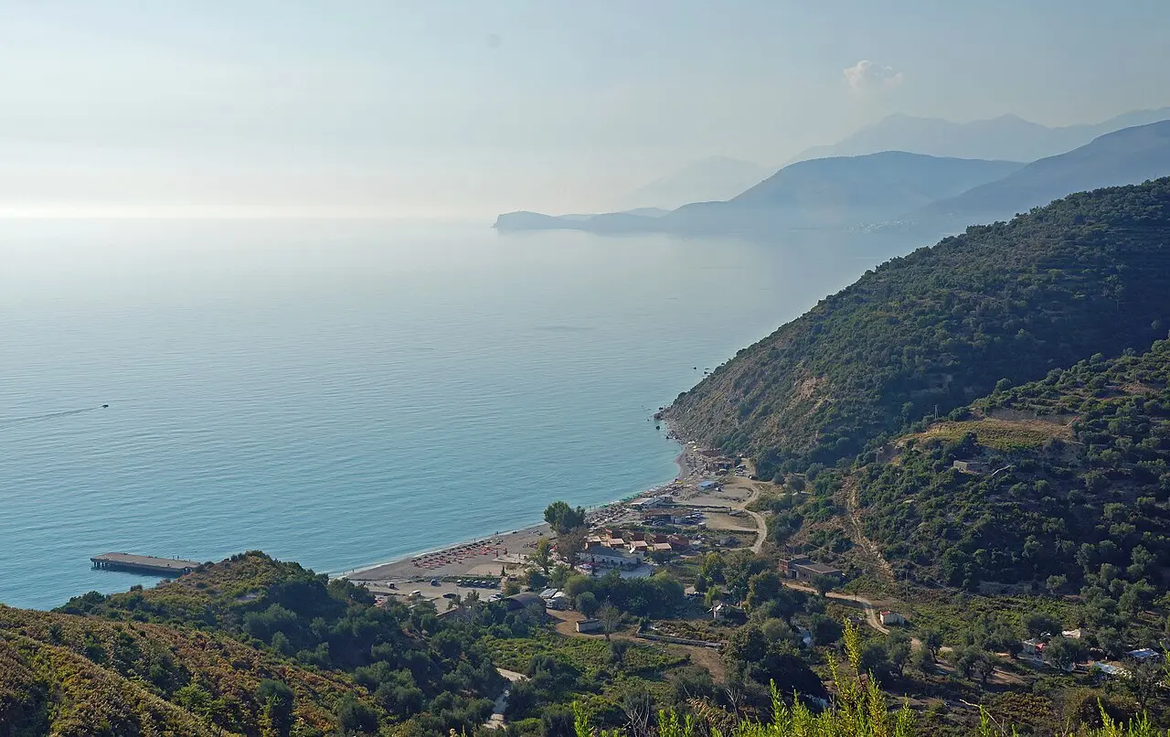 A pebble cove on the Albanian Riviera backed by green mountains