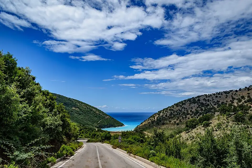 The winding coast road descending toward Kakome Bay north of Saranda