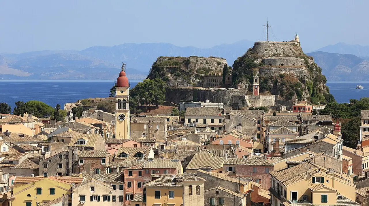 The Old Fortress and the red rooftops of Corfu Old Town seen across the water in Greece