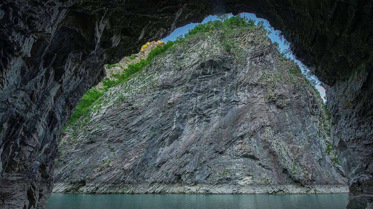 Turquoise water of the Shala River in northern Albania with forested cliffs rising on both sides