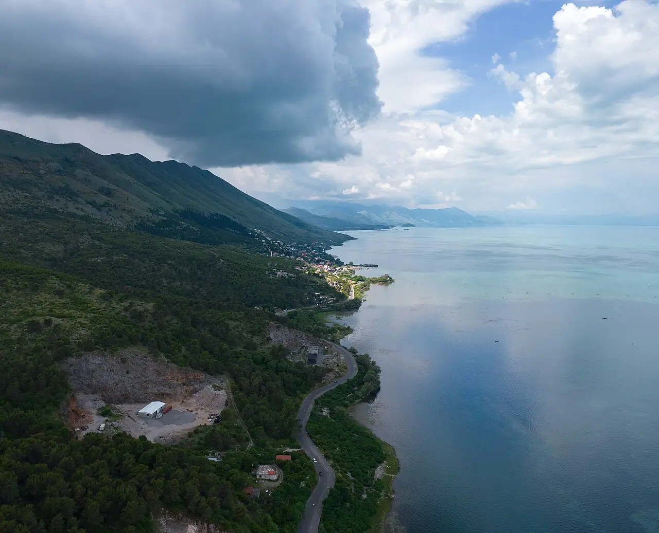 The lakeside village of Shiroka on Lake Shkodra with mountains behind