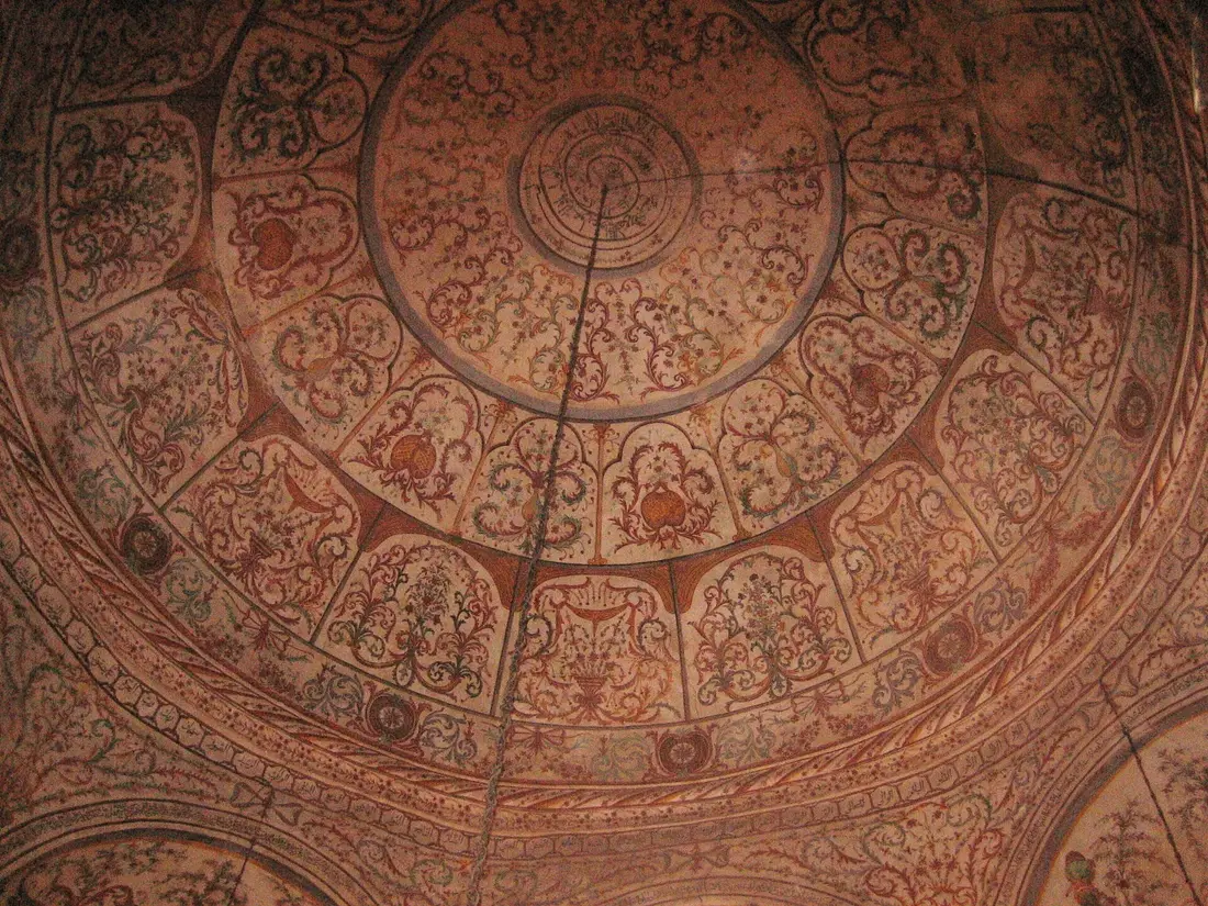 Painted dome inside Et'hem Bey Mosque covered in floral and landscape frescoes