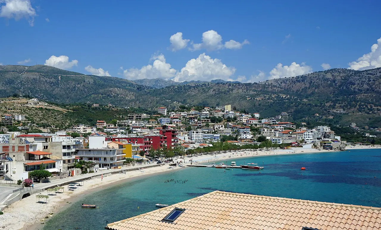 Himara town and its turquoise bay and beach below the Ceraunian Mountains, seen from above