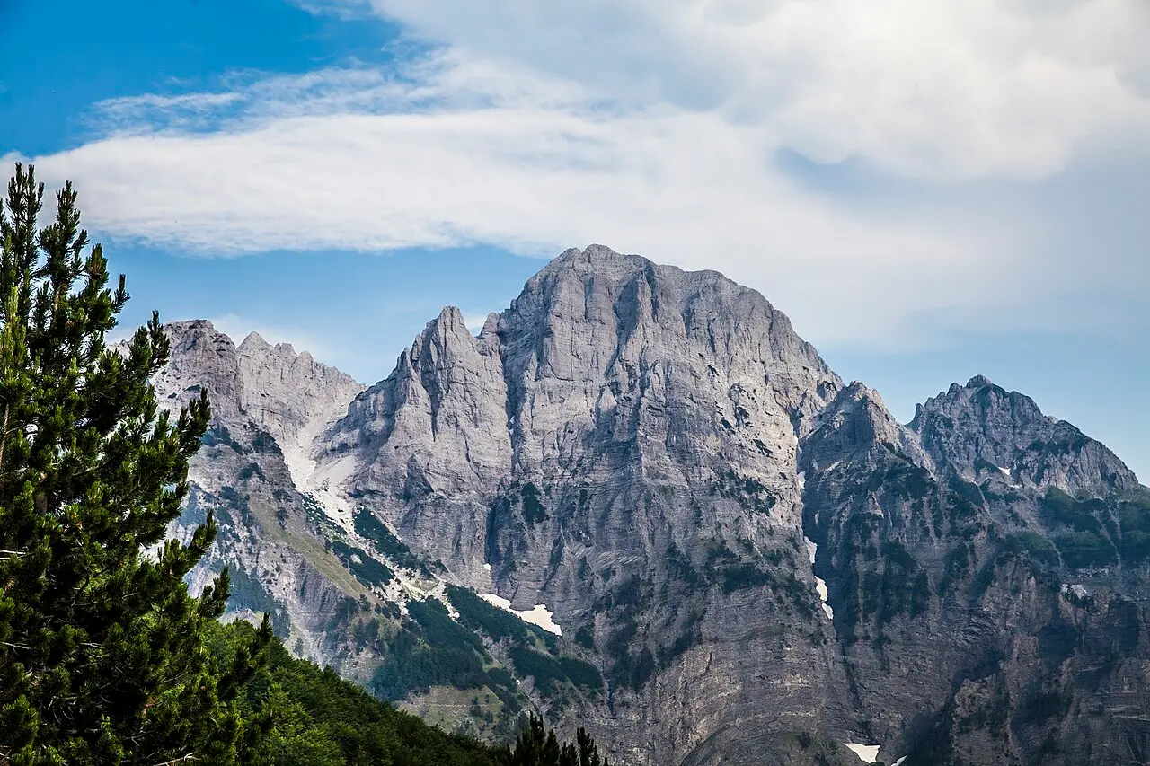 The rocky saddle of the Valbona Pass with bare peaks rising on either side