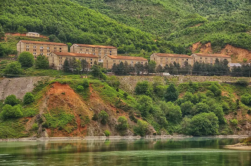 Apartment blocks above a reservoir landing at Fierza, the transfer point between the Koman ferry and Valbona