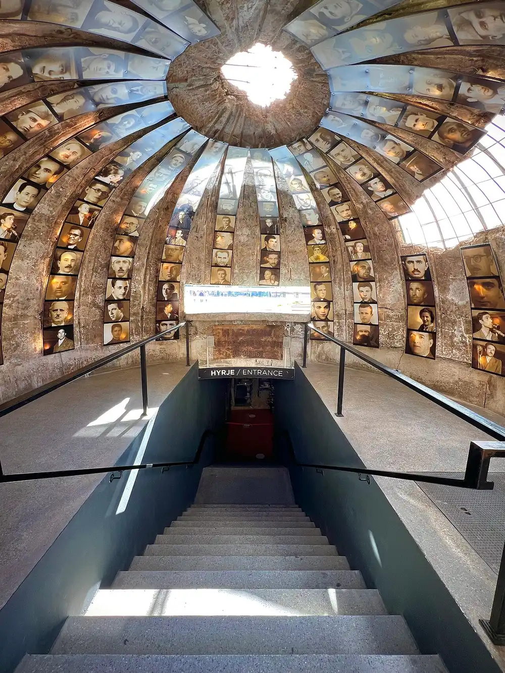 The domed atrium of the Bunk'Art 2 museum in Tirana with portraits on the walls
