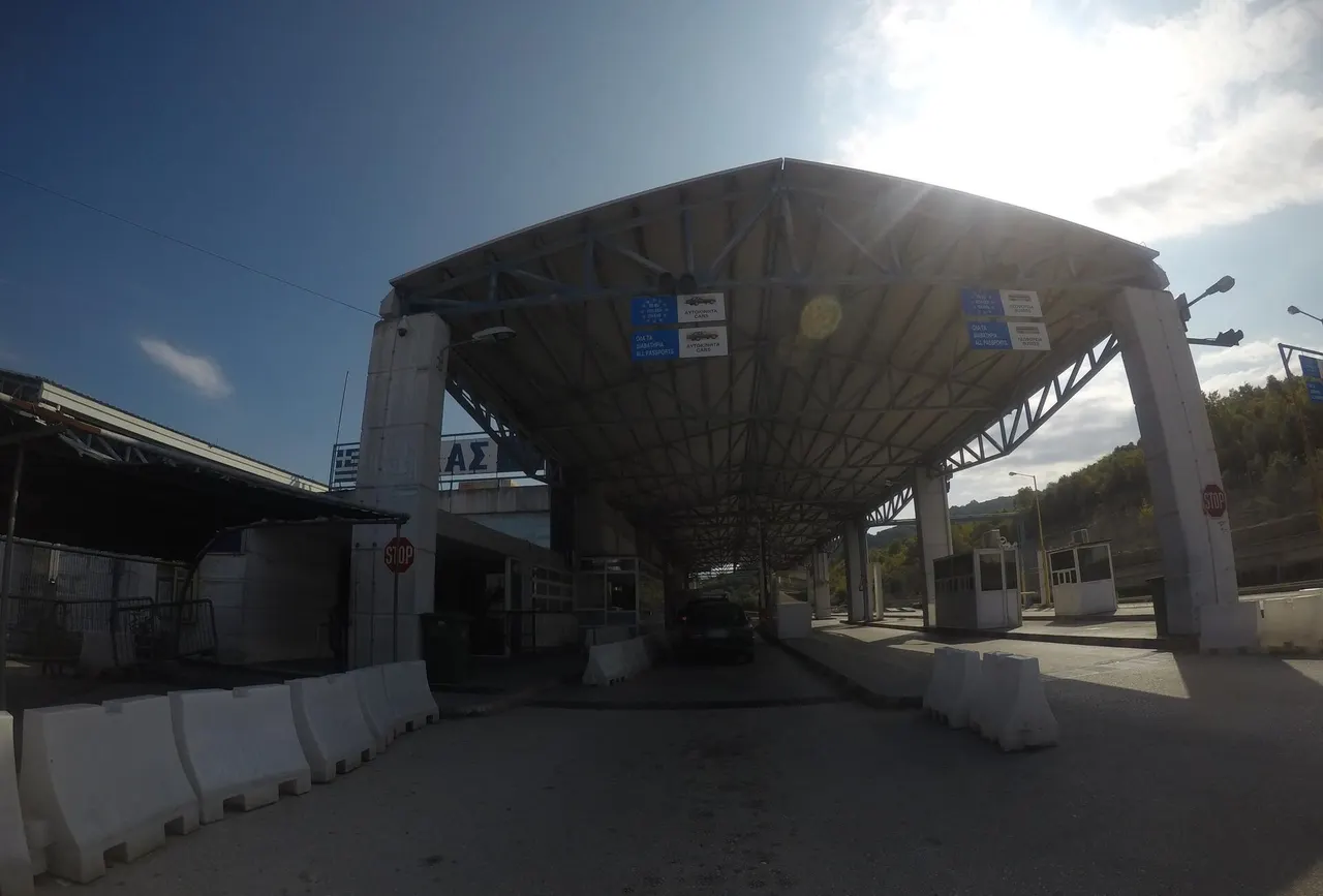 The covered Greek checkpoint at Kakavia, with blue signs above separate lanes for EU passports, all passports, cars and buses