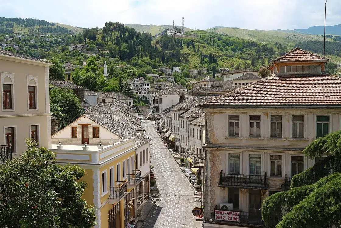 Grey slate roofs of Gjirokaster packed up the hillside below the fortress