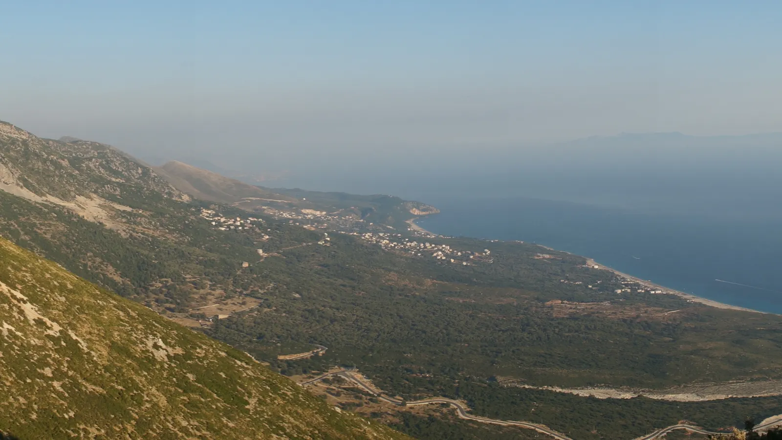 The view from the Llogara Pass down the mountainside to a coastal village and the Ionian Sea, on the road to Himara