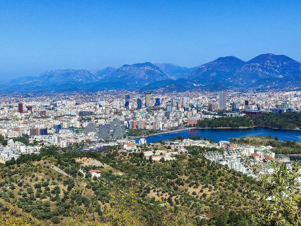 Tirana seen from the hills to the south, the artificial lake in front of the city and the Dajti mountains behind