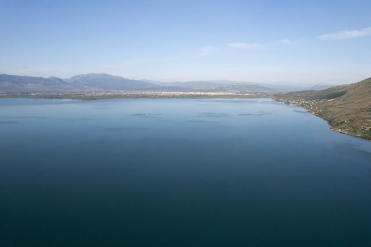 Lake Shkodra with the city of Shkodra spread along the far shore and mountains behind, in northern Albania