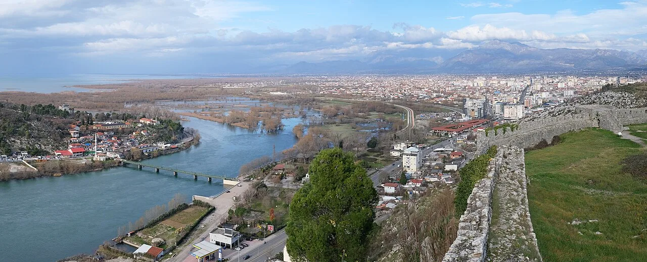 Rozafa Castle on its hill above Shkodra, with the surrounding plain and rivers spread out below under a wide sky