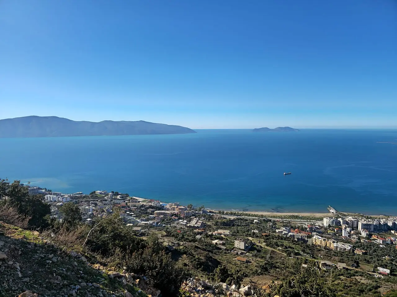 The stone ruins of Kanina Castle on a hill above Vlora and its bay