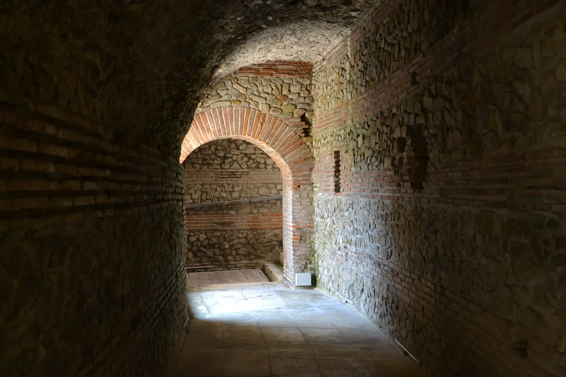 Stone seating tiers of the Roman amphitheatre of Durres set among the modern town
