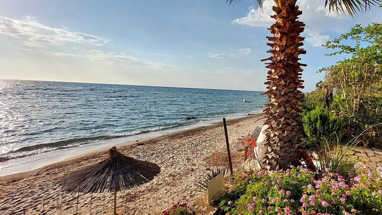 Wide sandy Kallm beach north of Durres with the Adriatic and the built-up coast beyond