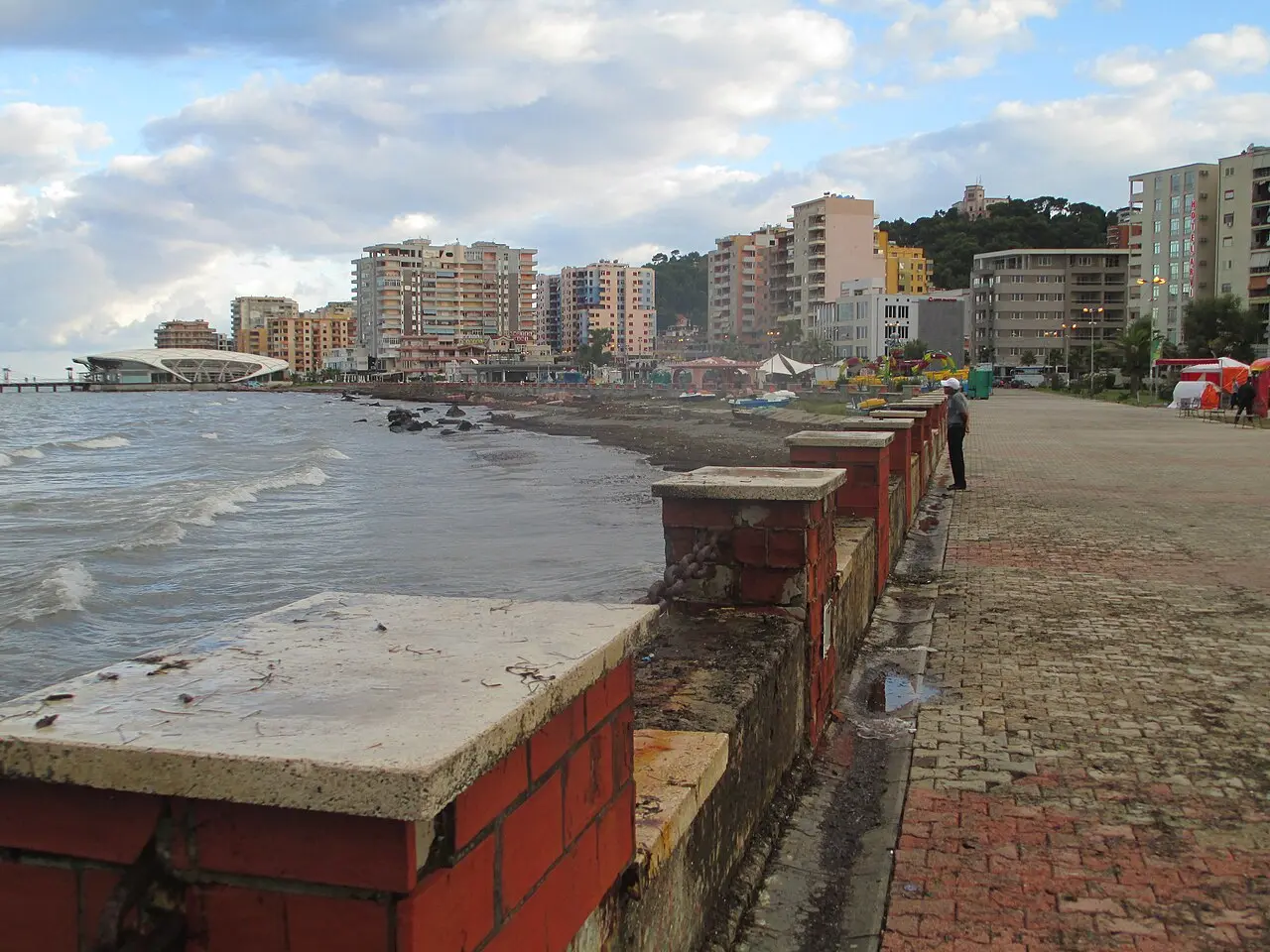 Wooden and concrete seafront promenade along Durres Plazh with beach umbrellas and the Adriatic