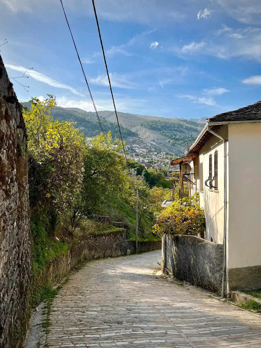Steep cobbled lane between stone walls in Gjirokaster Old Town