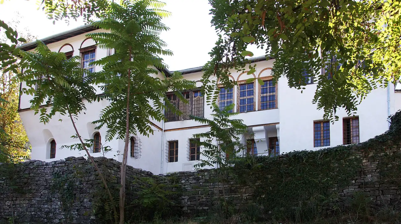 Restored Ottoman stone house with wooden shutters and a slate roof in Gjirokaster Old Town