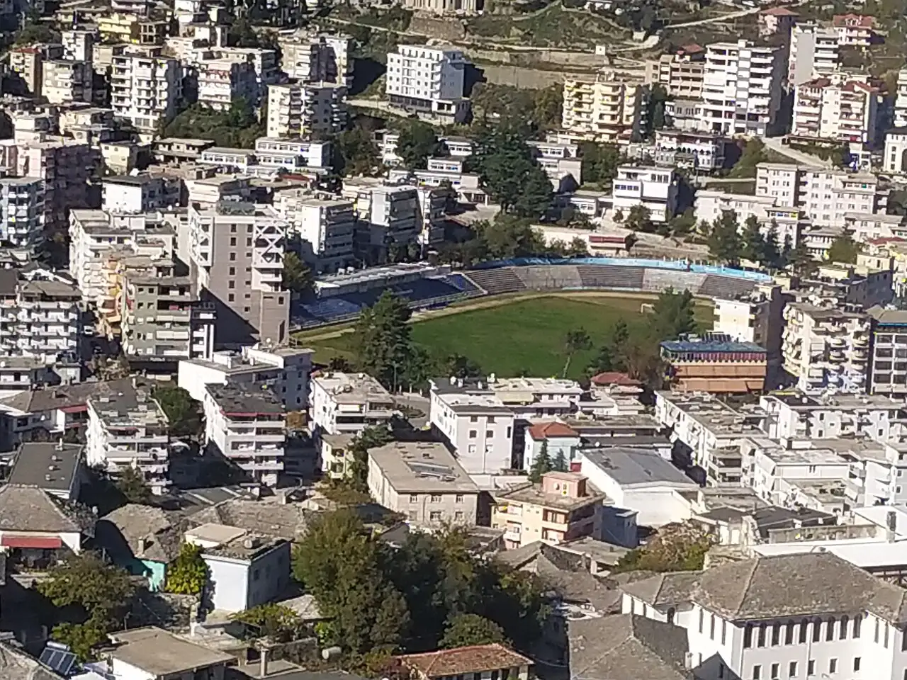 Football stadium and modern buildings on the valley floor seen from Gjirokaster Castle